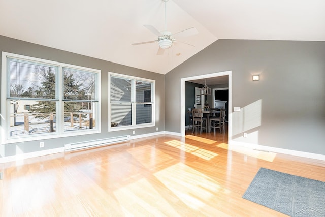 interior space with ceiling fan, wood-type flooring, vaulted ceiling, and baseboard heating