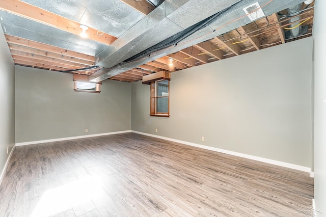 basement with hardwood / wood-style floors