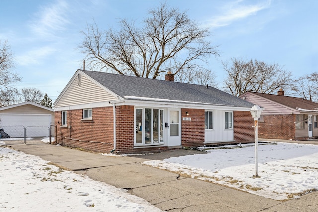 view of front facade with an outbuilding and a garage