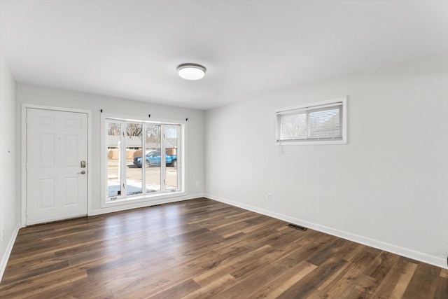 empty room with dark hardwood / wood-style floors