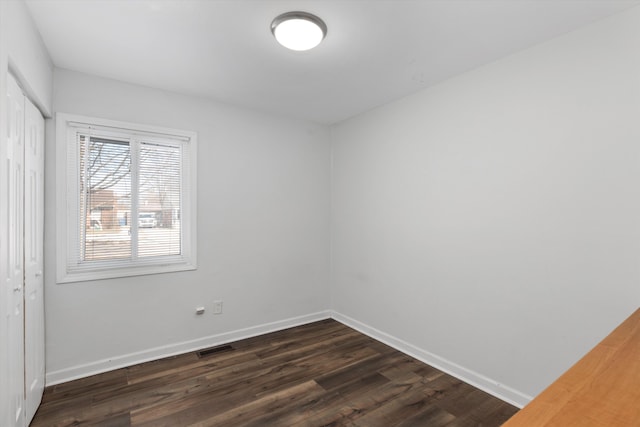 empty room featuring dark hardwood / wood-style flooring