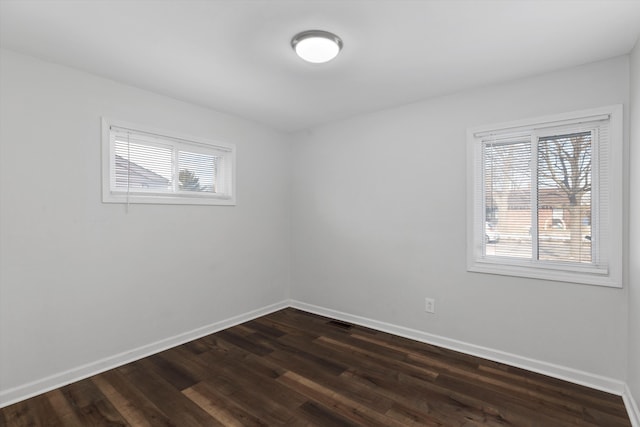 empty room featuring dark hardwood / wood-style flooring