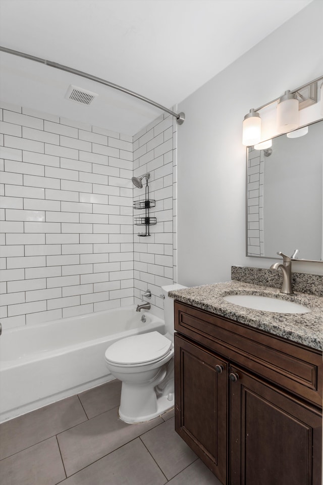 full bathroom featuring tile patterned flooring, vanity, tiled shower / bath combo, and toilet