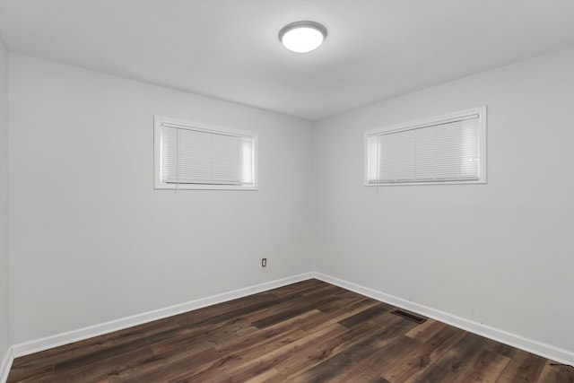 empty room featuring dark wood-type flooring