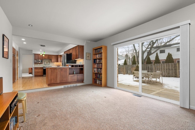 unfurnished living room with light carpet