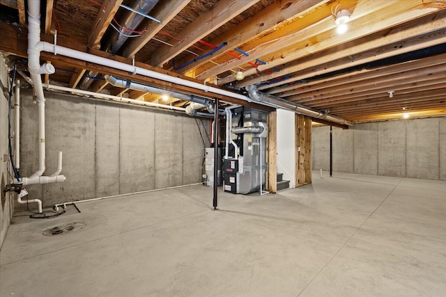 basement featuring water heater and heating unit