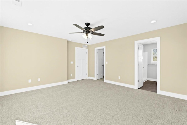 interior space with carpet floors, ceiling fan, and ensuite bathroom