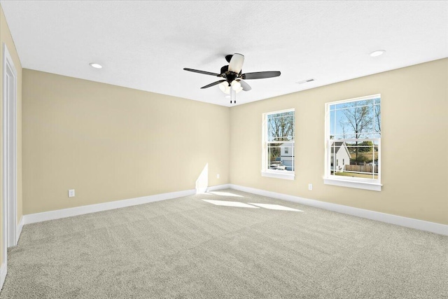 spare room featuring ceiling fan and carpet flooring