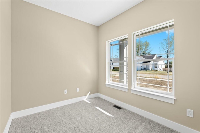 carpeted empty room with plenty of natural light