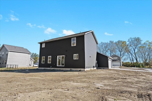 back of house featuring a garage