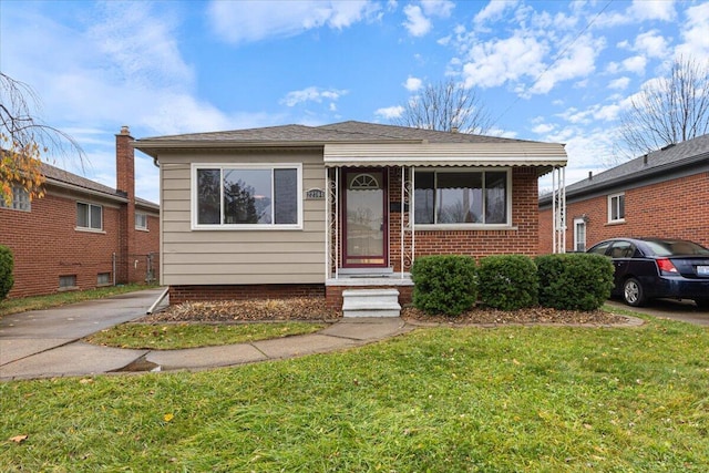 bungalow-style home featuring a front yard