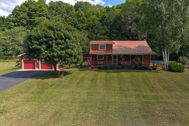 view of front facade featuring a garage, a front lawn, and covered porch