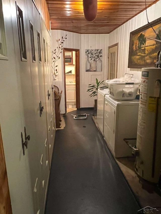 washroom featuring laundry area, washer and clothes dryer, gas water heater, and wooden ceiling