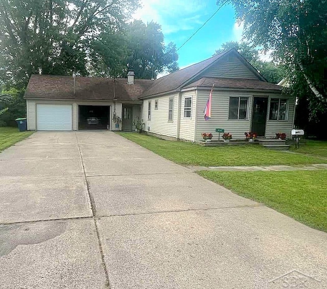 ranch-style home featuring a garage, driveway, and a front yard