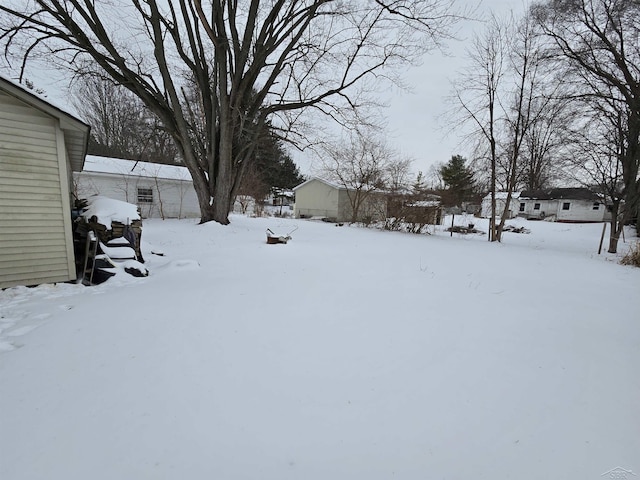 view of yard layered in snow