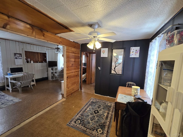 interior space with ceiling fan and a textured ceiling