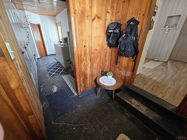 hall featuring wood walls