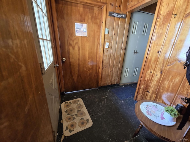 doorway with wood walls