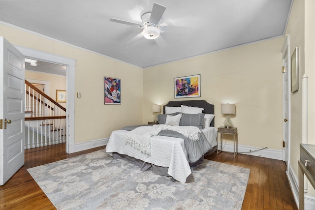 bedroom featuring ceiling fan, ornamental molding, and dark hardwood / wood-style floors