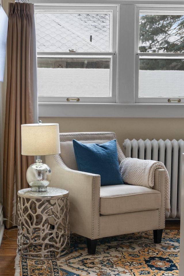 sitting room featuring hardwood / wood-style flooring and radiator heating unit