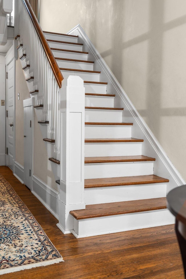 stairs featuring wood-type flooring