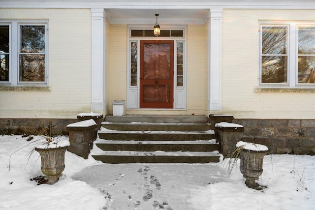 view of snow covered property entrance