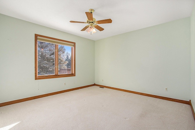 carpeted spare room with ceiling fan