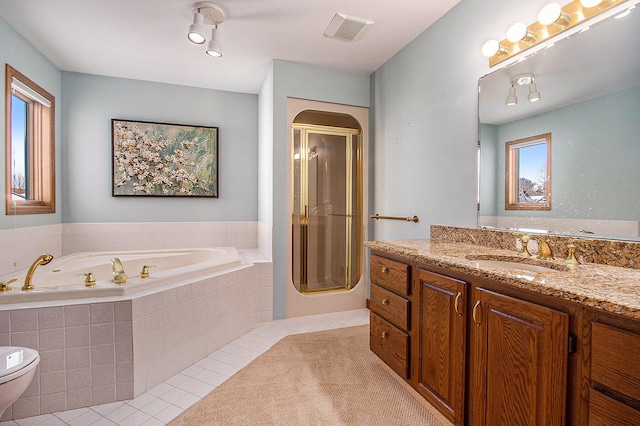 full bathroom with vanity, plenty of natural light, tile patterned floors, and plus walk in shower