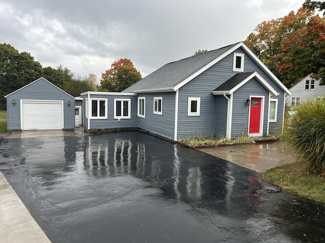 view of front of property with a garage and an outdoor structure