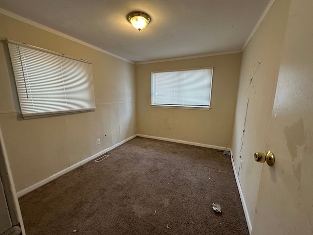 carpeted empty room featuring ornamental molding