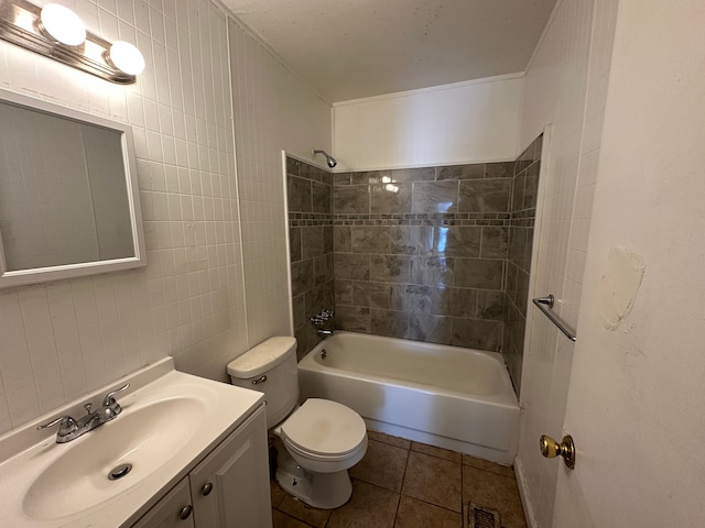 full bathroom with tile walls, tiled shower / bath combo, vanity, tile patterned floors, and toilet