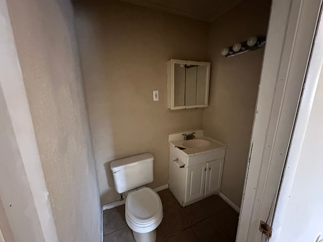 bathroom featuring tile patterned flooring, vanity, and toilet