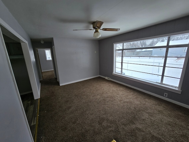 carpeted spare room with ceiling fan