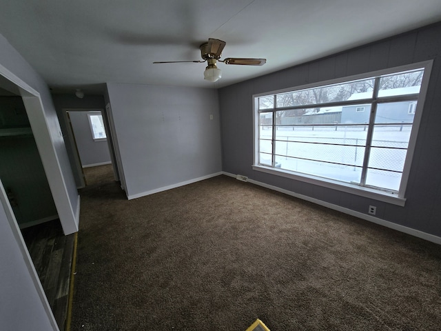 carpeted empty room featuring ceiling fan