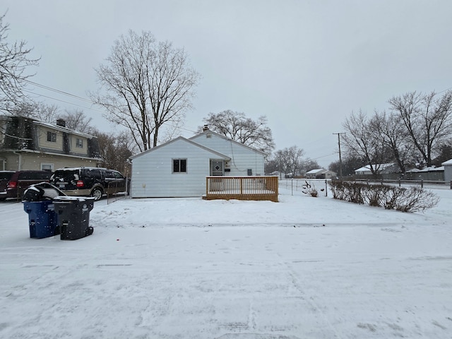 view of snow covered exterior with a deck