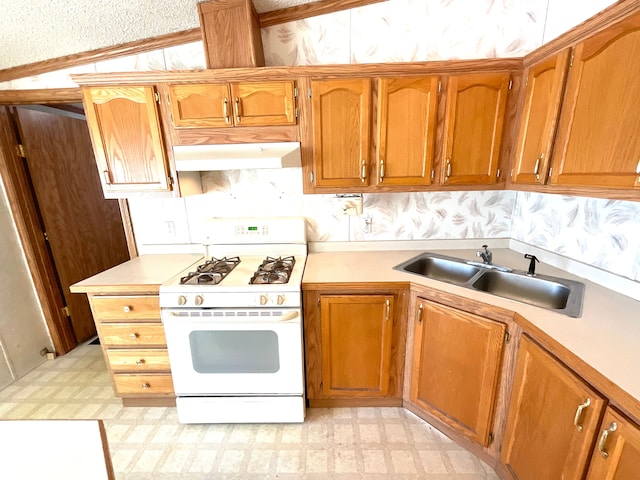 kitchen featuring lofted ceiling, sink, crown molding, and white range with gas stovetop