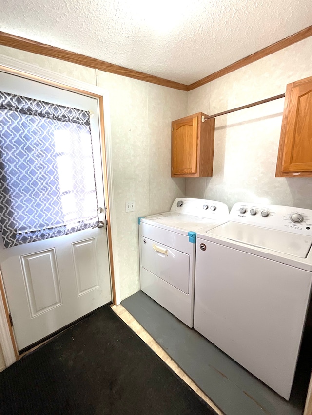 laundry area with cabinets, crown molding, independent washer and dryer, and a textured ceiling