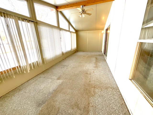 unfurnished sunroom with lofted ceiling with beams and ceiling fan