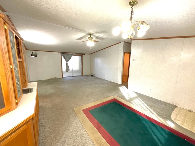 interior space with ceiling fan with notable chandelier and a textured ceiling