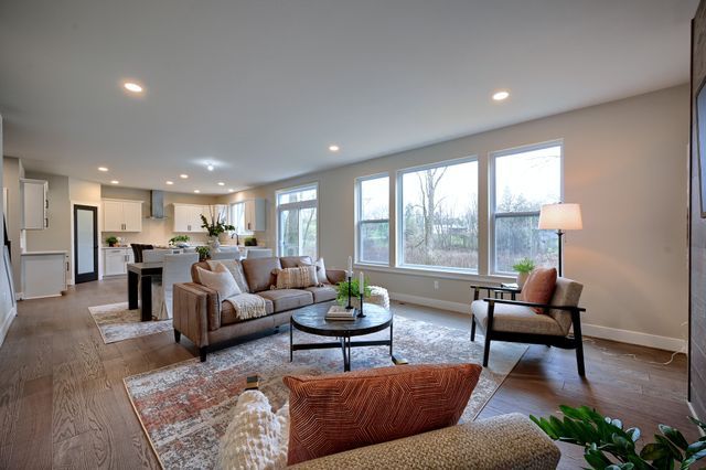 living room with wood-type flooring and a healthy amount of sunlight