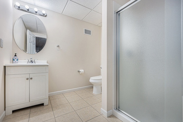 bathroom with a shower with door, vanity, tile patterned floors, and toilet