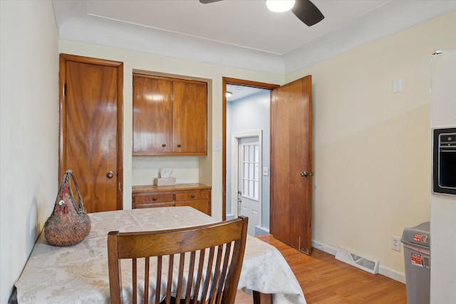 dining area with ceiling fan and light wood-type flooring