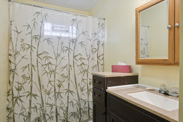 bathroom with walk in shower and vanity