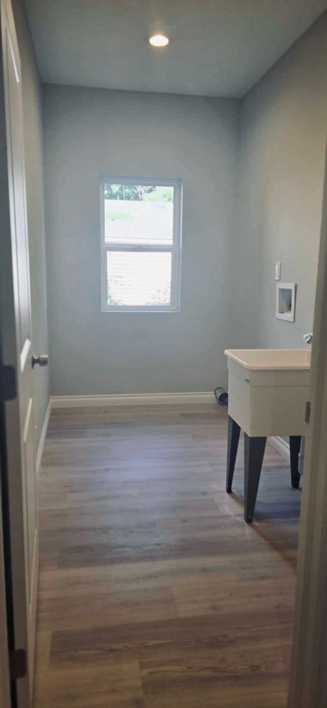 interior space with dark hardwood / wood-style flooring and washer hookup