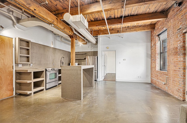 kitchen featuring stainless steel appliances, a center island, hanging light fixtures, beamed ceiling, and brick wall