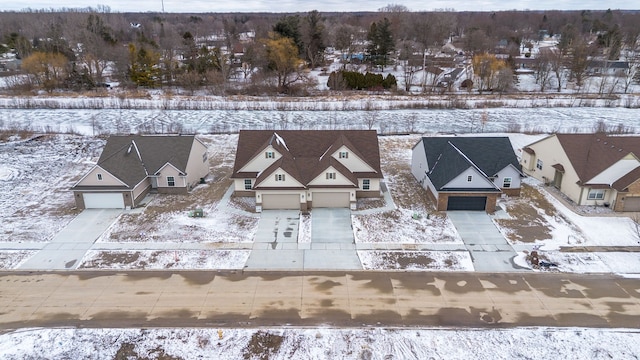 snowy aerial view featuring a residential view