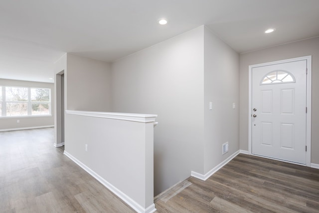 foyer featuring recessed lighting, visible vents, baseboards, and wood finished floors