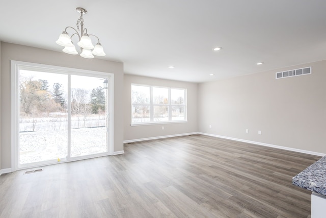 interior space featuring baseboards, visible vents, and wood finished floors