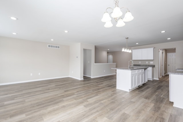 kitchen featuring recessed lighting, visible vents, light wood finished floors, and an inviting chandelier