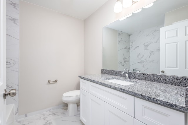 full bathroom featuring toilet, marble finish floor, baseboards, and vanity